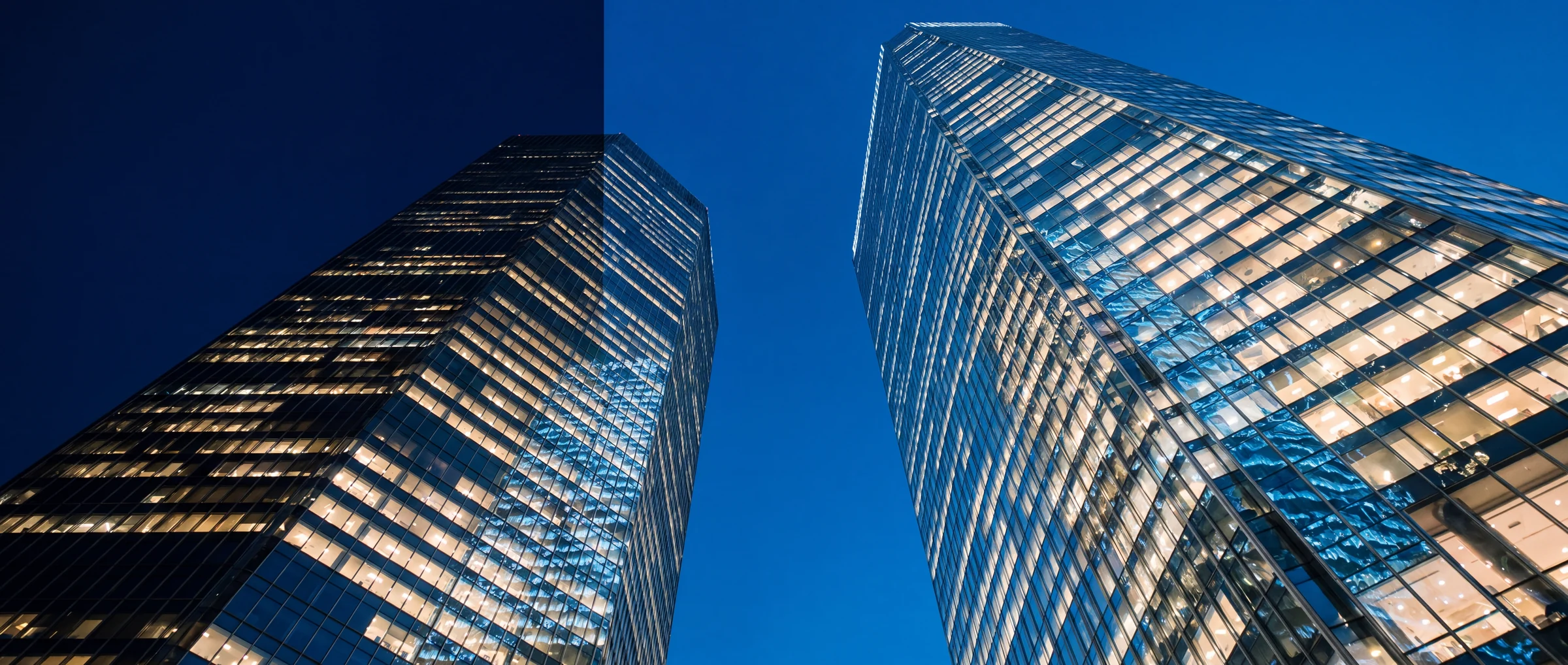 Glass towers at blue hour, looking up