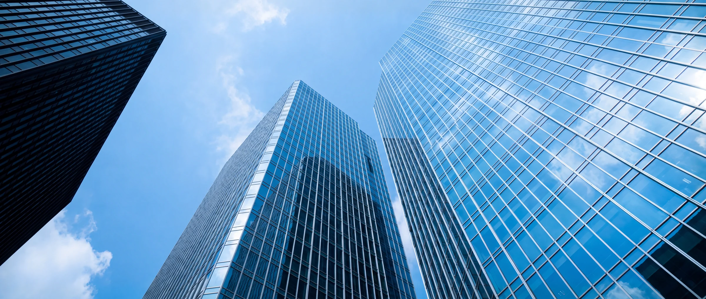 Glass towers rising into cloud, looking up