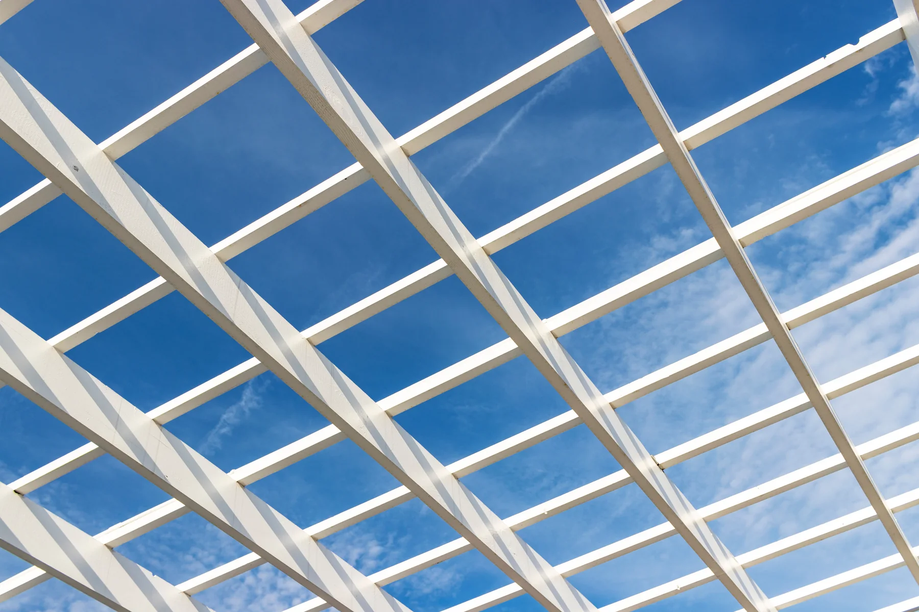 A white steel lattice against a blue sky
