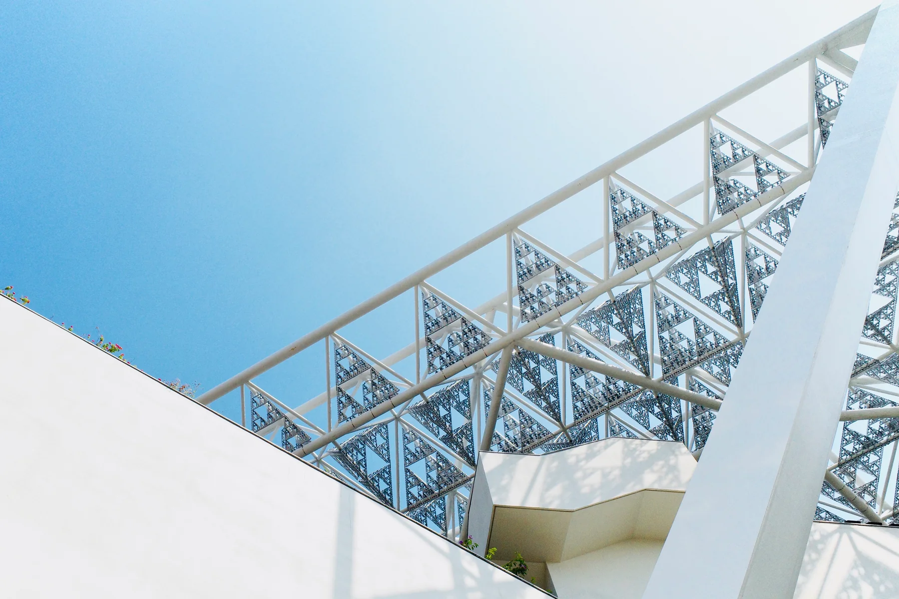 White truss structure, pale blue sky