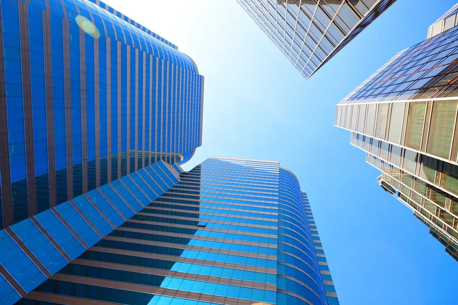 Blue glass office towers looking up