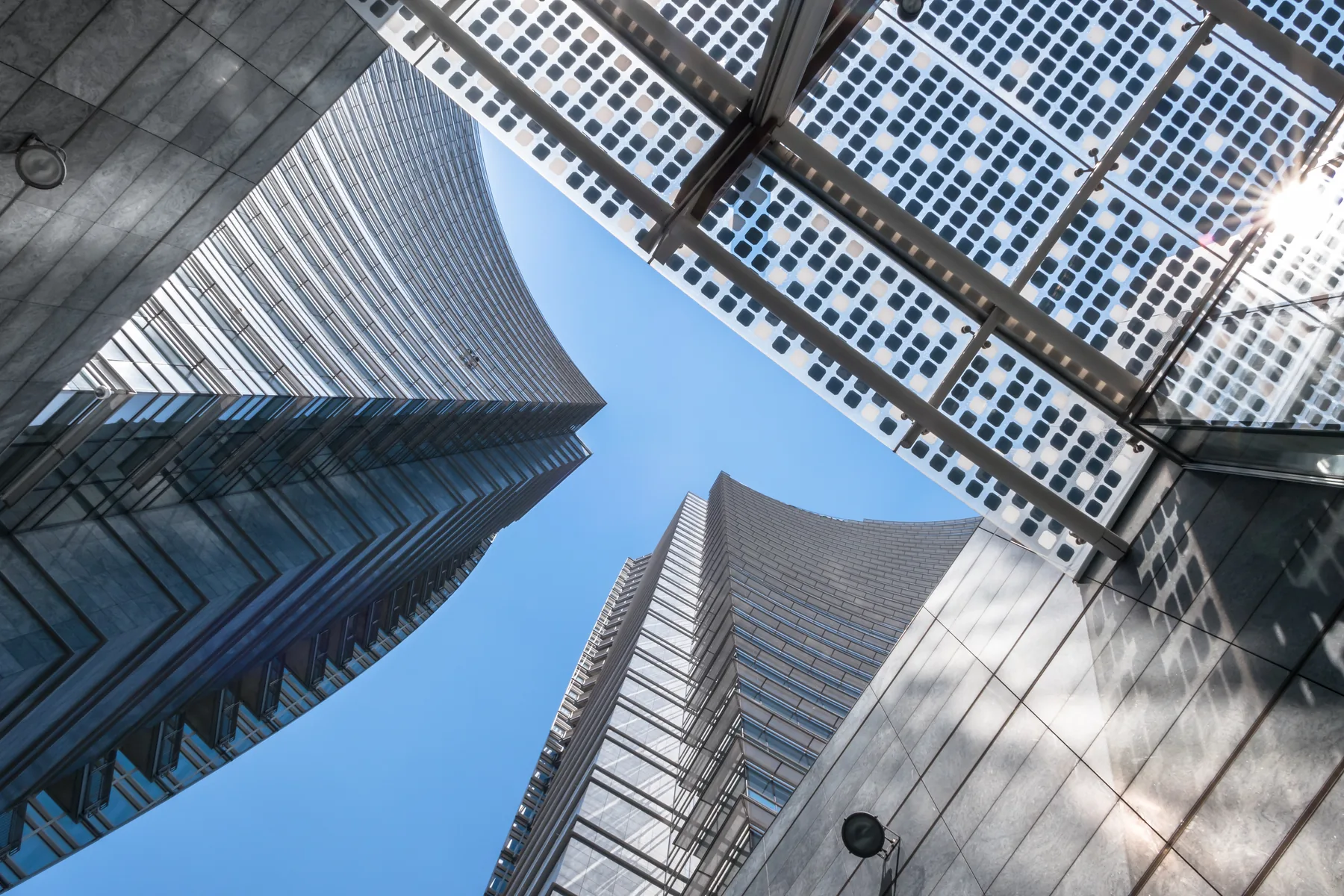 Curved glass towers and a gridded facade