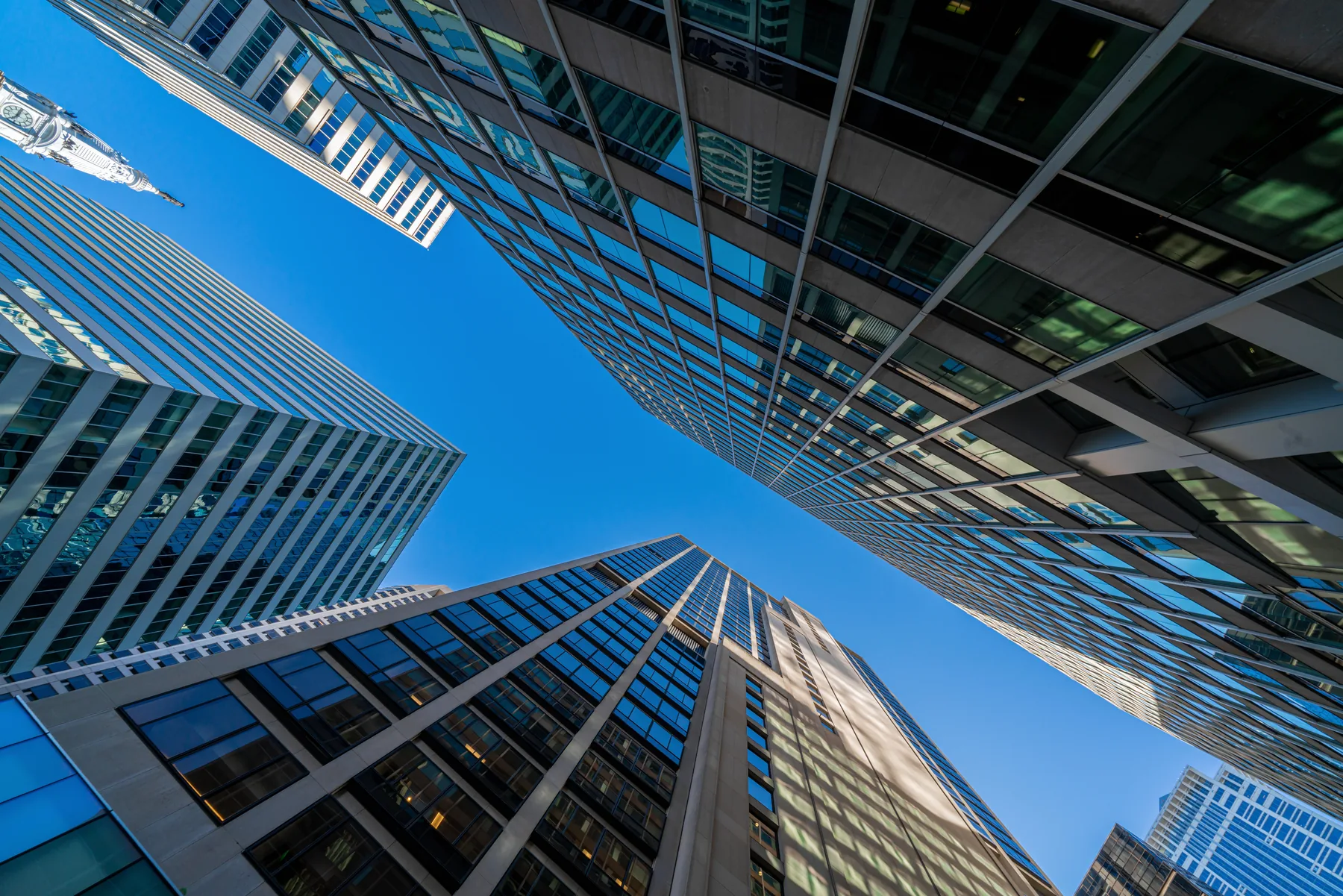 Dark glass towers against a deep blue sky