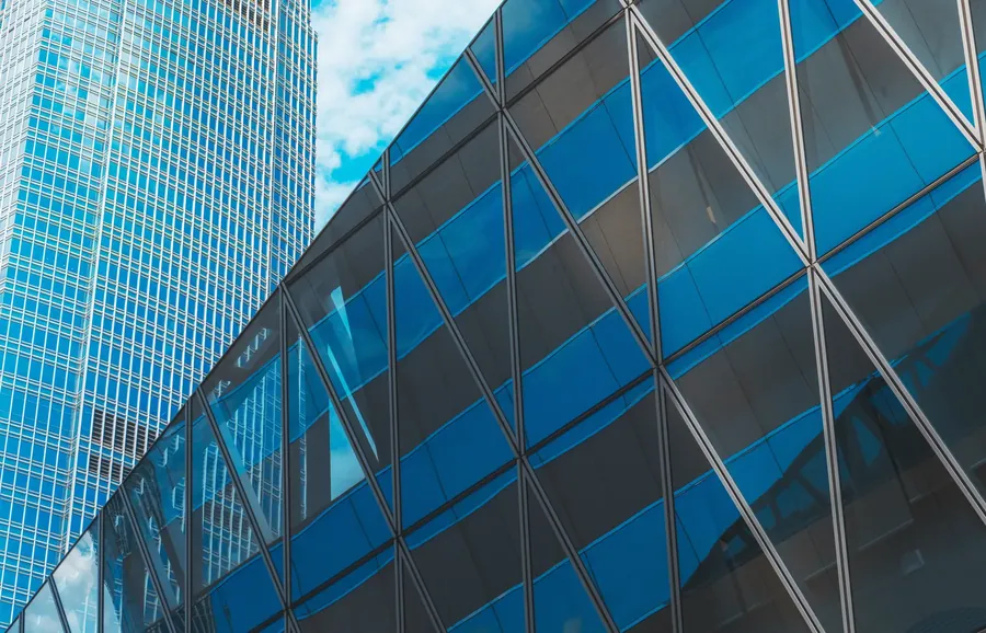 Diagonal glass grid facade, looking up