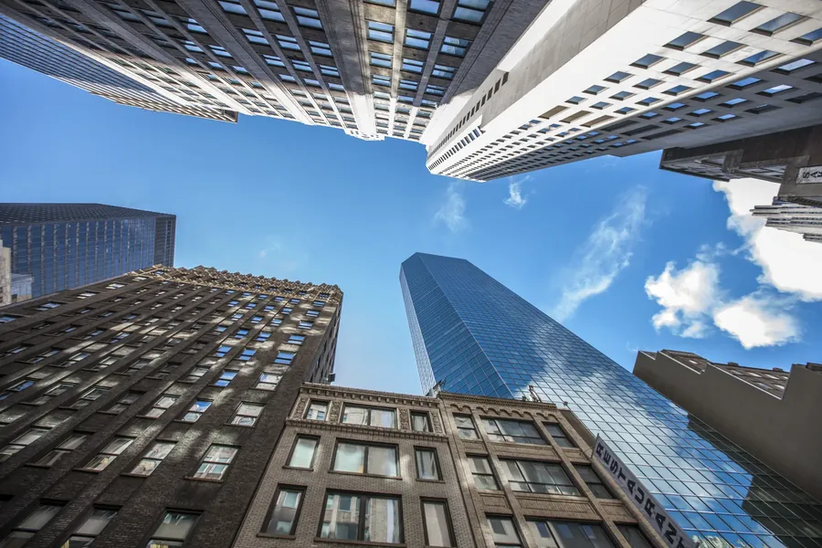 Brick blocks and a glass tower, looking up