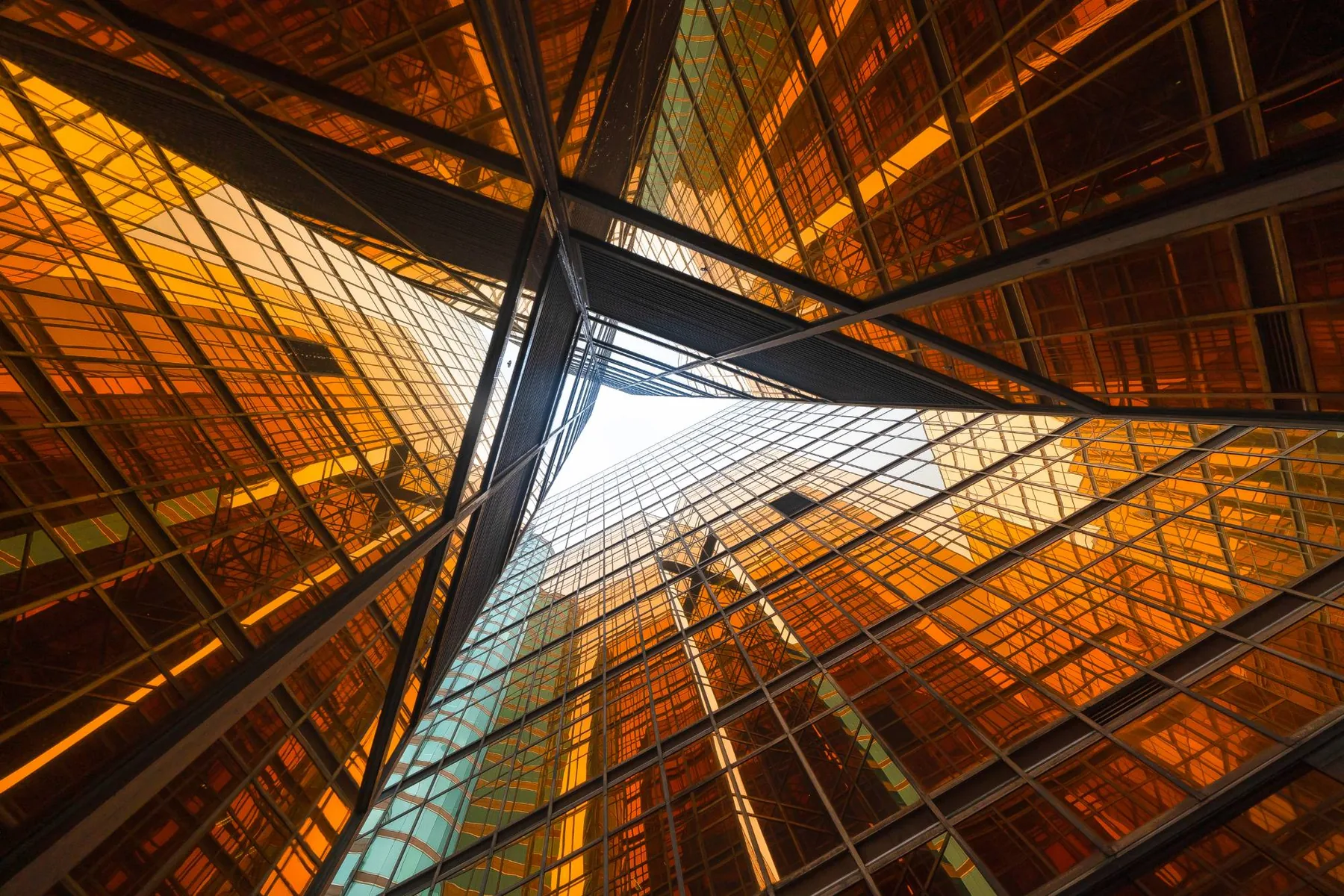 Amber glass towers looking up to a triangle of sky