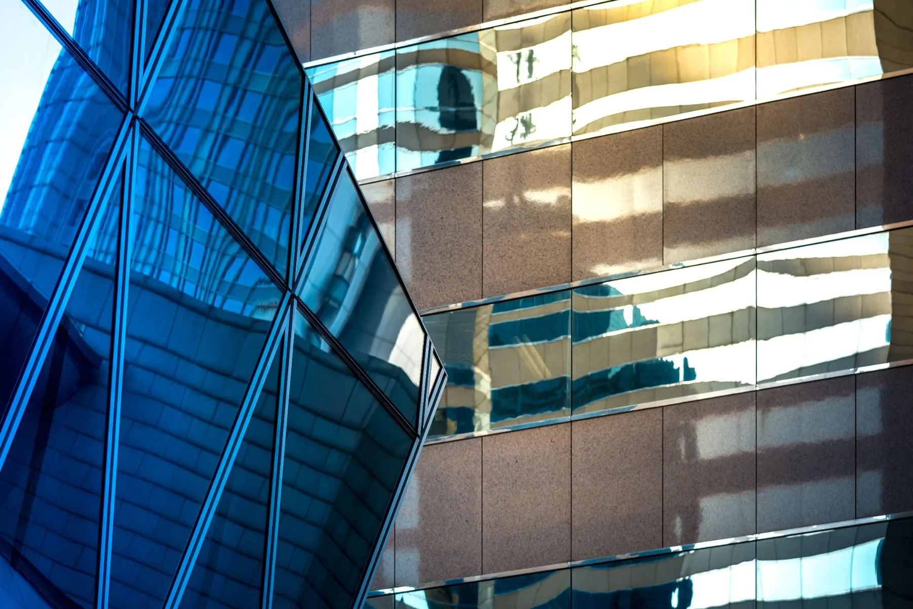 Faceted blue glass beside granite and gold-lit windows