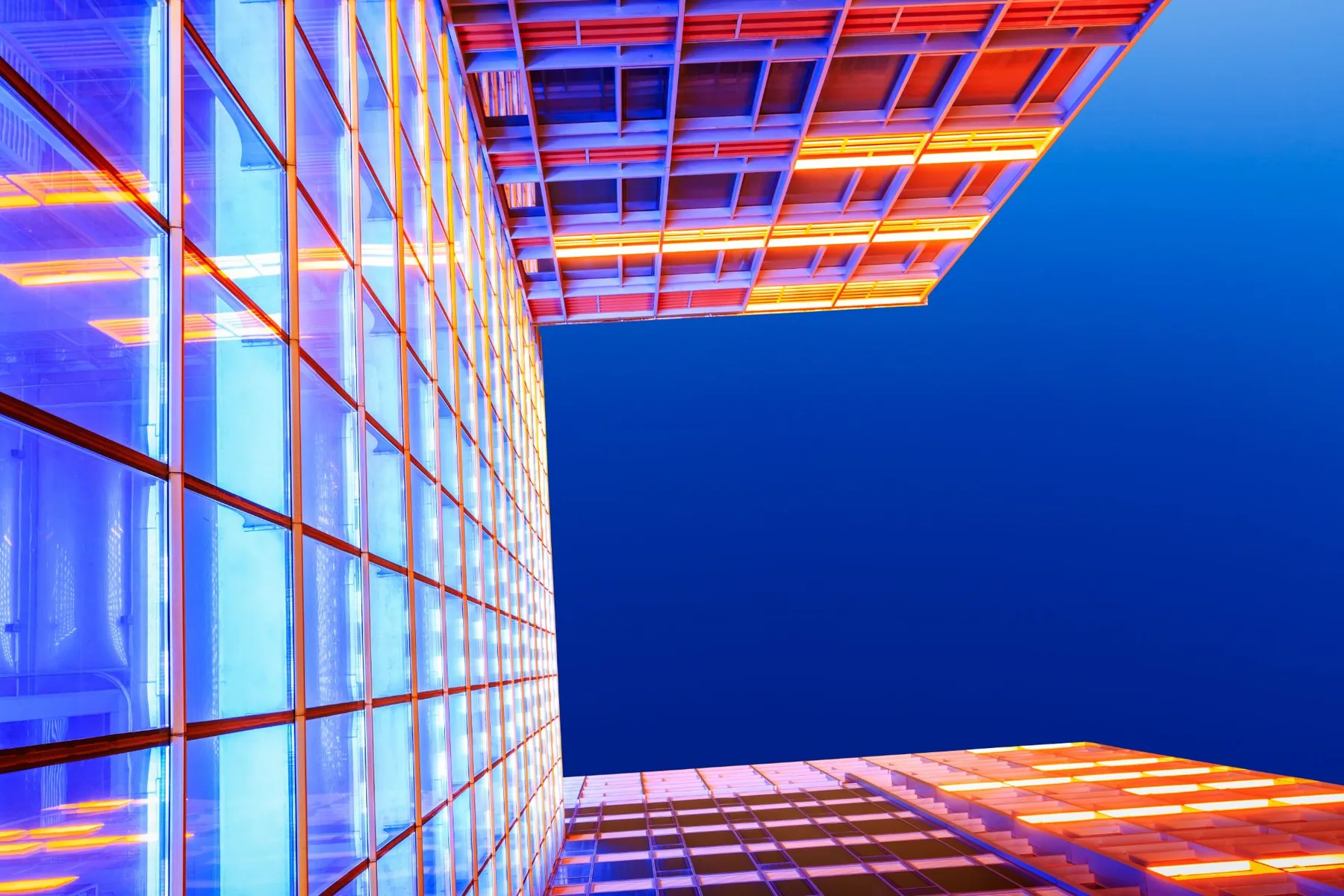 Lit glass towers from below at dusk
