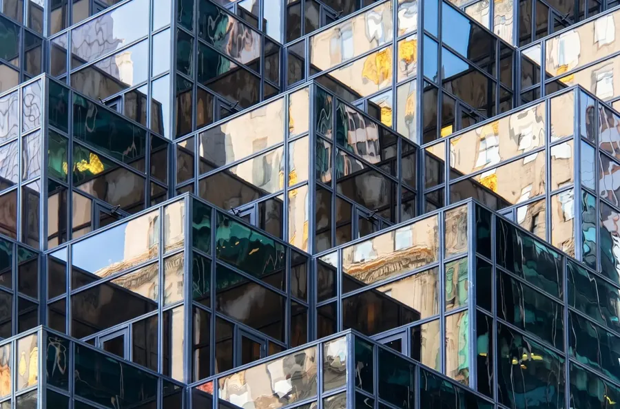 Stepped glass tower, stone reflections