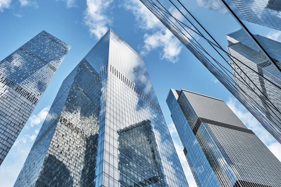 Mirrored glass towers looking up