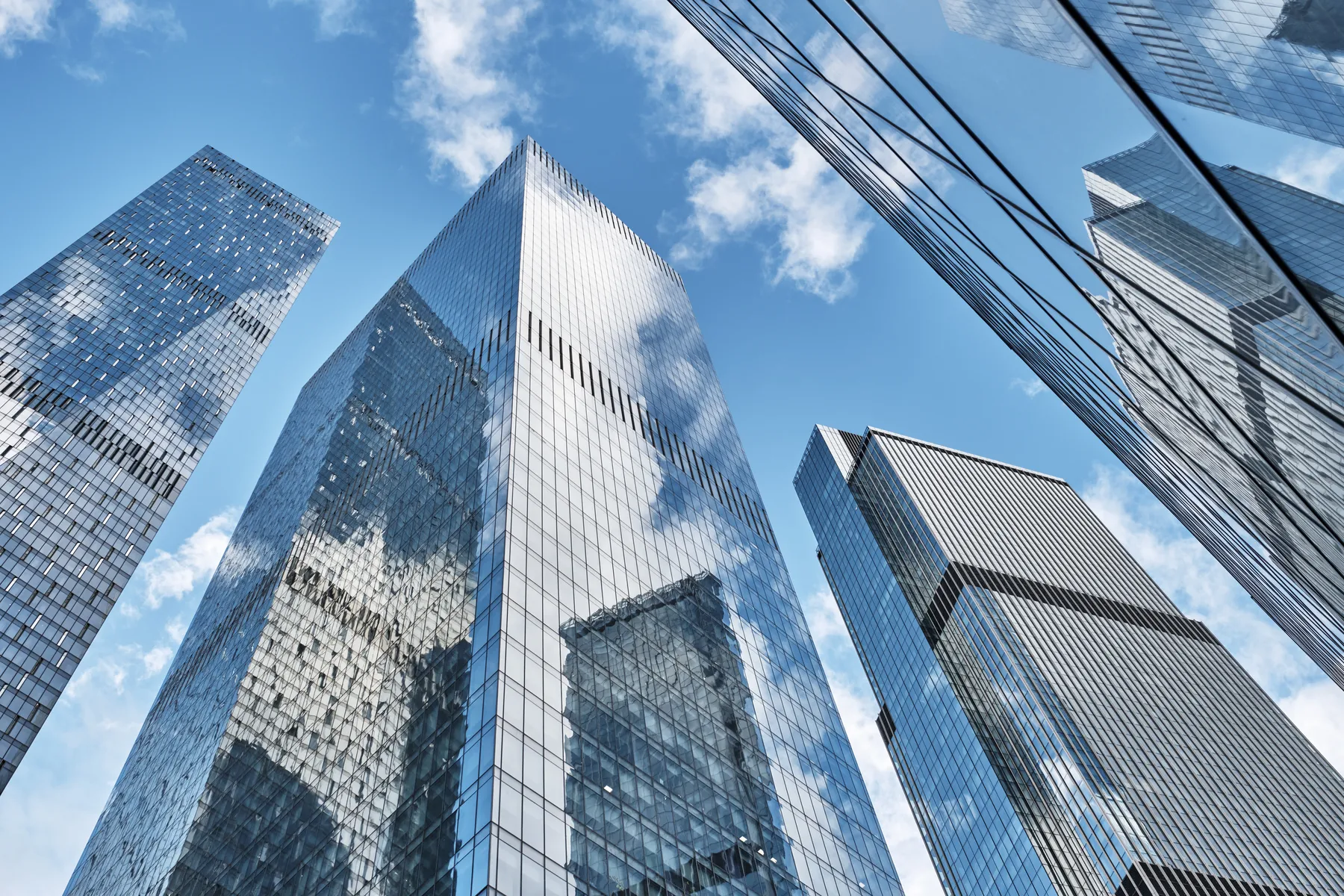 Mirrored glass towers looking up