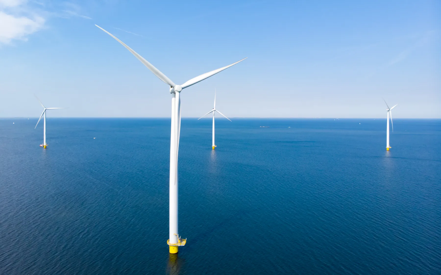Offshore wind turbines on a blue sea