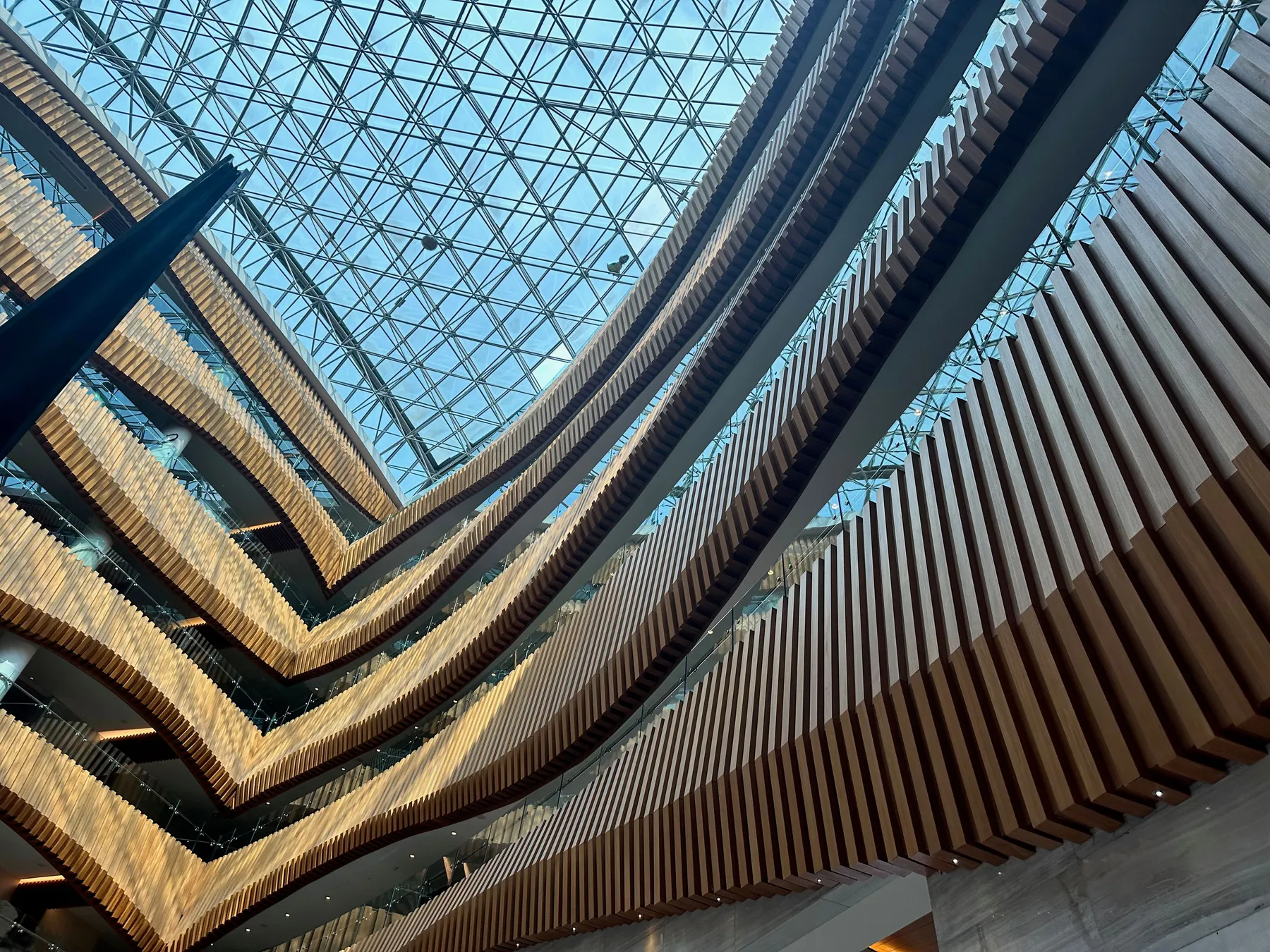 A timber-finned atrium under a glass roof