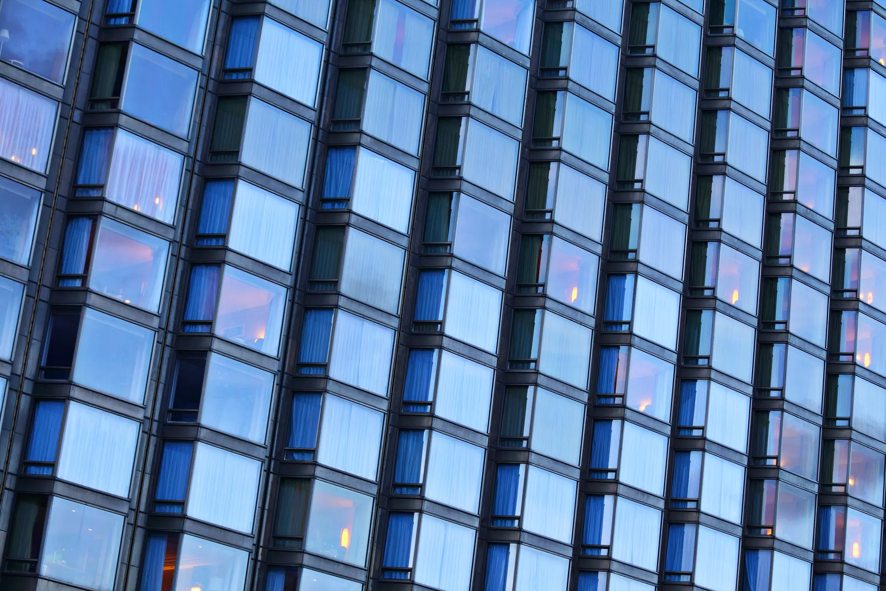 A blue glass facade at dusk