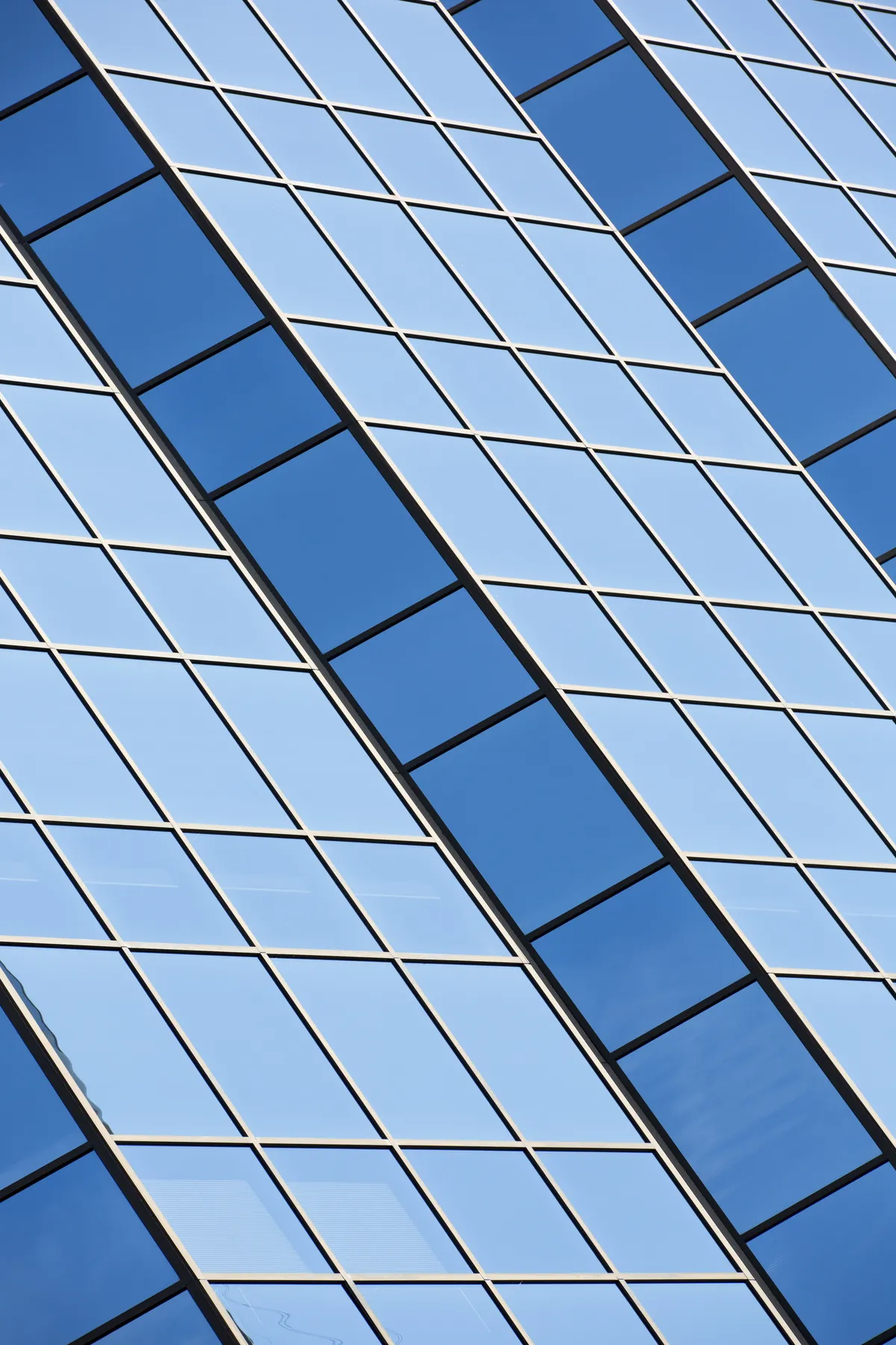 A blue glass facade, rising