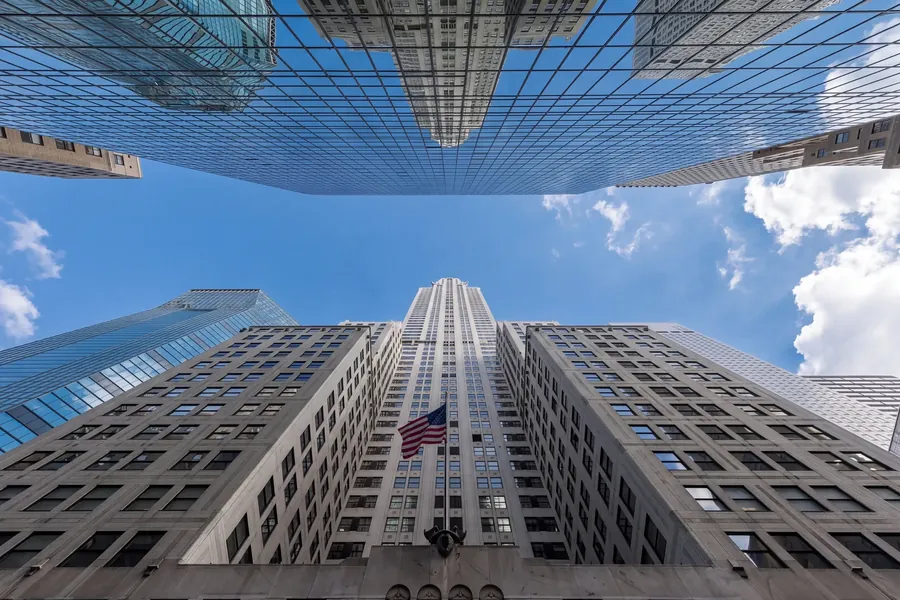 Manhattan towers looking up, flag